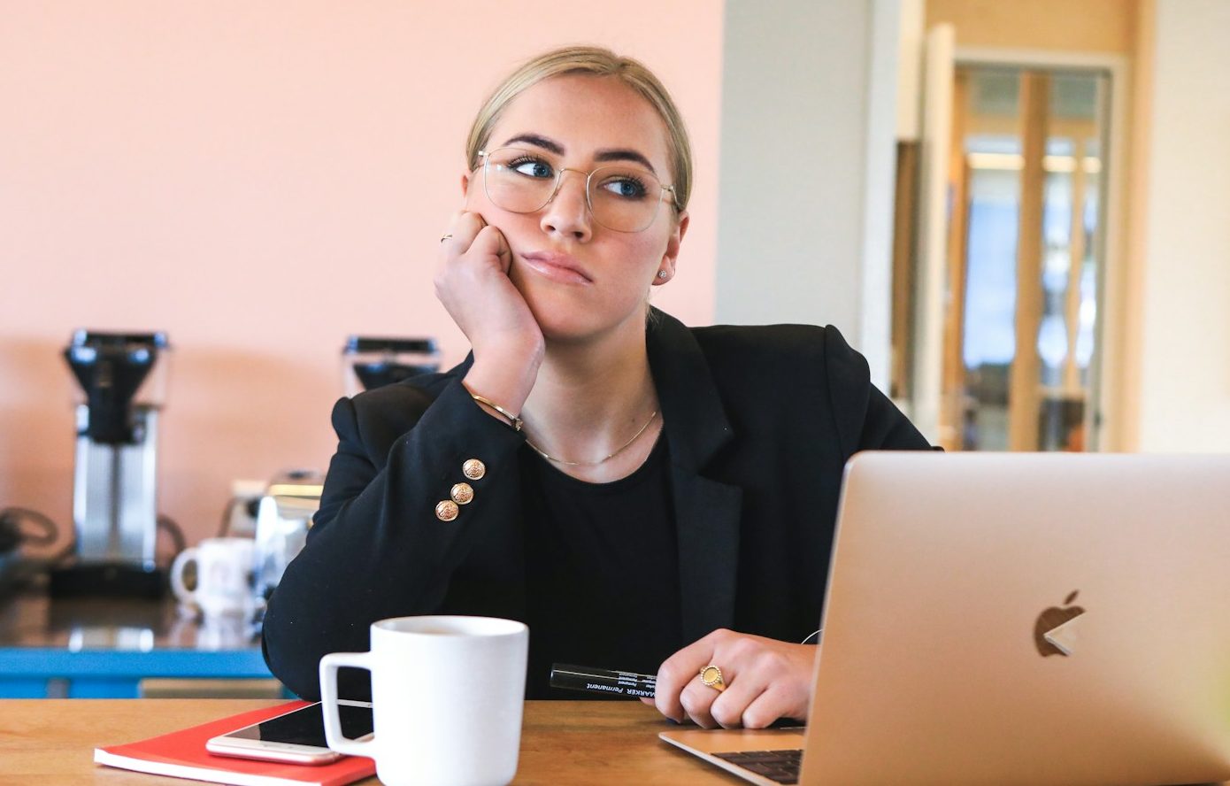 woman in black long sleeve shirt using macbook