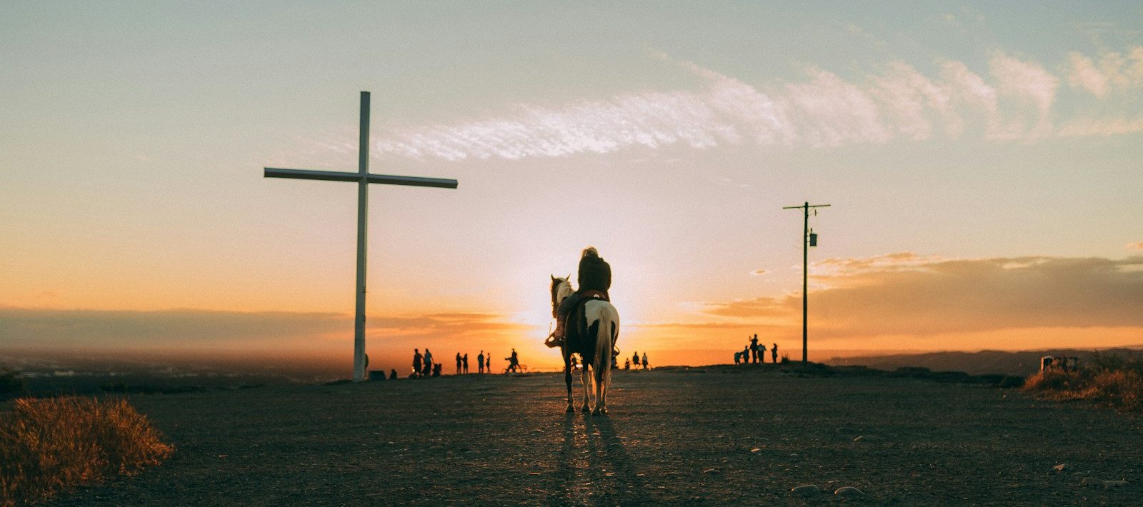 silhouette of people walking on beach during sunset
