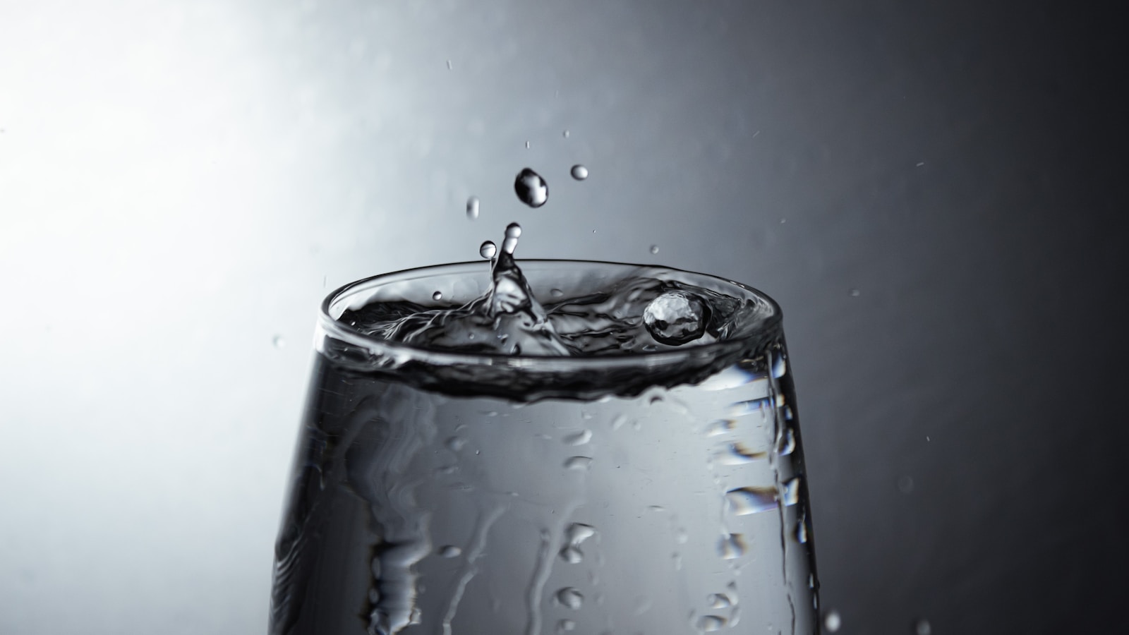 a glass filled with water on top of a table